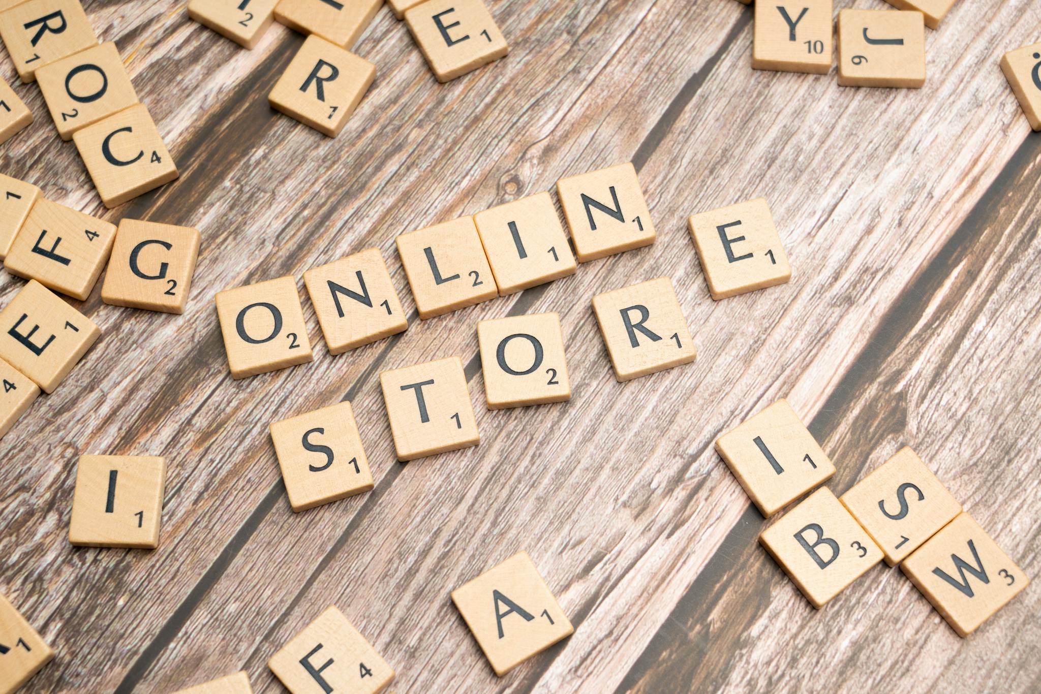 About Scrabble tiles spelling 'online store' on a rustic wooden background.